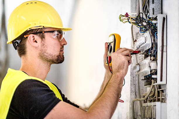 Electrician repairing circuit breakers in industrial electric panel. Electrician repairing circuit breakers in industrial electric panel.